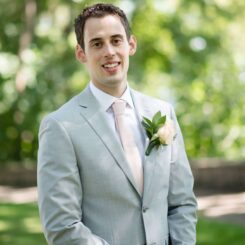 Daniel Gustin standing in a park smiling